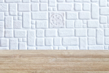 An empty wooden table and a background for a product presentation with a defocused background of a kitchen apron. Product mounting display, can be used to demonstrate or mount your products. Layout fo