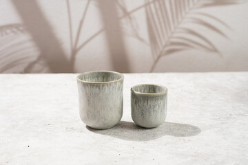 empty grey ceramic espresso and coffee mugs on a grey background