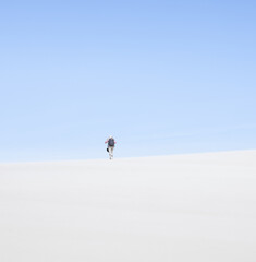 Fototapeta na wymiar hiking up a high dune in the desert