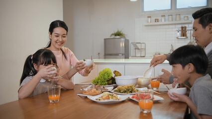 Family concept of 4k Resolution. Asian parents and children eating together in the house.