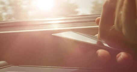 Sunlight flare over businessman using smartphone while traveling in train metro car - fast commuting 4K DCI footage - Powered by Adobe