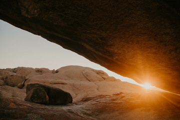 sun beam streaking through an arch in namibia desert