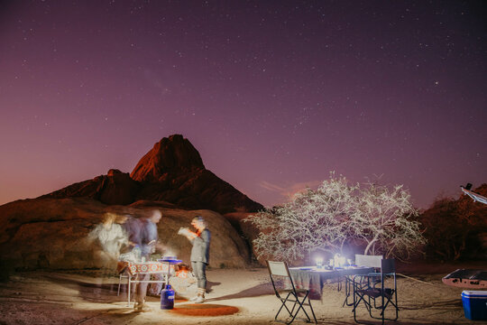 camping under the night sky in the desert of namibia