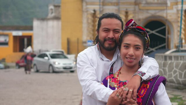 Couple in the city. Portrait of a young married couple looking at the camera with a church in the background. 