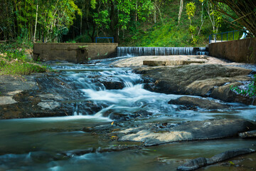 Naklejka na ściany i meble Stream in the hill with rapids water at Macuco town, State of Rio de Janeiro, Brazil.
