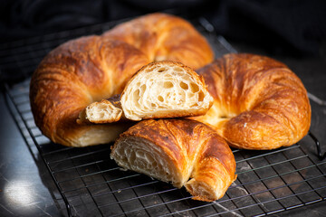 Detailed close-up of delicious buttery traditional croissants with a crescent moon shape.
