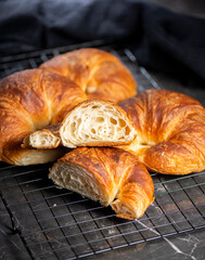 Detailed close-up of delicious buttery traditional croissants with a crescent moon shape.