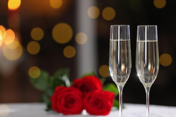 Glasses of champagne on table in restaurant, space for text. Romantic dinner