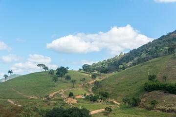 Landscape of a valley and mountains with grass and blue sky in the city of Macuco, State of Rio de Janeiro, Brazil.
