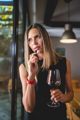one woman with glass of red wine and electronic cigarette device