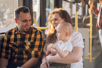 Parents riding a bus with their child during a day. © Zamrznuti tonovi