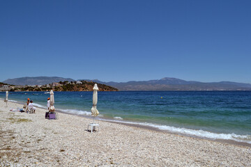 Beach in Loutra Oraias Elenis meaning Baths of beautiful Helen, a village in Corinthia, Greece, situated on the coast of the Saronic Gulf.
