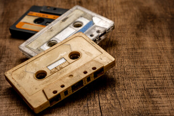 Old cassette tapes on a wooden table.