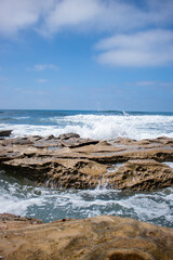 Fototapeta na wymiar Waves crashing on rocks