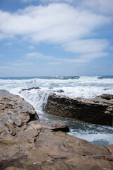 Fototapeta na wymiar Waves crashing on rocks