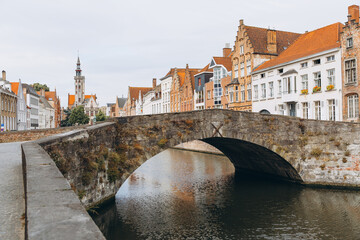Scenic city view of Bruges canal with beautiful medieval colored houses, bridge in the morning hour, Belgium