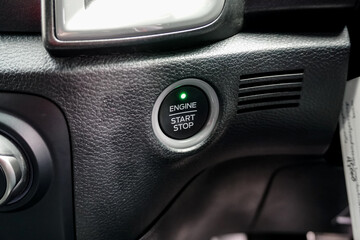 Fototapeta na wymiar Close up engine car start button. Start stop engine modern new car button,Makes it easy to turn your auto mobile on and off. a key fob unique ,selective focus 