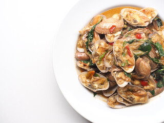 Dish of stir fried Thai clams with roasted chili paste on white background