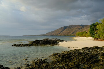 Fototapeta na wymiar Indonesia Alor Island - Ocean landscape with volcanic rocks and sand beach