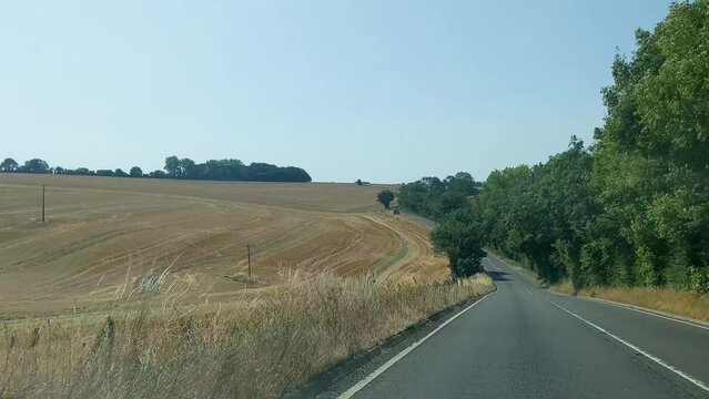 Driving Point Of View Smooth Car Dashcam Shot Past Scorched Fields And Blue Sky Dorset UK 4K