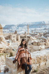 portrait of young happy attractive woman in snowy cappadocia