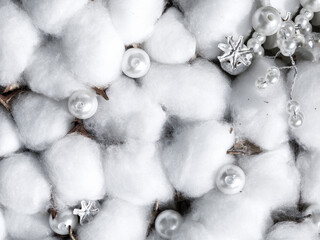 Christmas or winter composition. Dried cotton flowers, white beads, silver poppy snow flakes full frame close up background. Autumn, fall, winter wedding concept. Flat lay, top view, macro, copy space