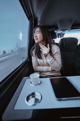Fototapeta na wymiar young asian woman having sore throat during her trip in a van
