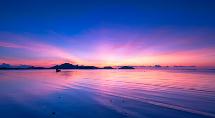 Obraz premium Landscape Long exposure of majestic clouds in the sky sunset or sunrise over sea with reflection in the tropical sea.Beautiful cloudscape scenery.Amazing light of nature Landscape nature background