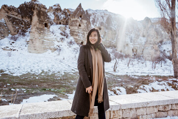 portrait of young happy attractive woman in snowy cappadocia