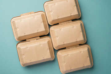 Recycle Eco-friendly disposable food container made of kraft paper on a green background