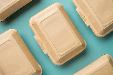 Recycle Eco-friendly disposable food container made of kraft paper on a green background