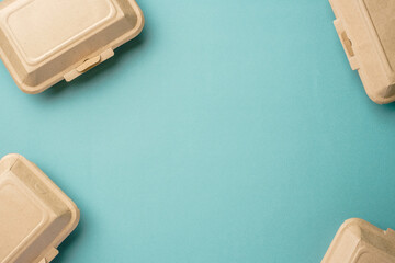 Recycle Eco-friendly disposable food container made of kraft paper on a green background