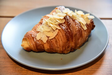 Croissant almon with aisin in a dish on a table.