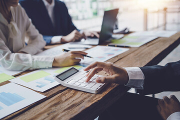 Close-up shot of marketing meeting to analyze and record information, graph, chart, sale strategie, marketing, balance sheet, income statement and quarterly result of company.