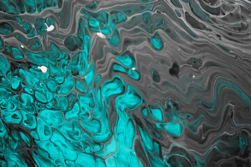 Fluid Art acrylic paints. Abstract mixing gray waves and turquoise bubbles. Liquid flows splashes. Marble effect background or texture