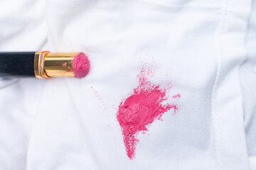 Lipstick stain on white shirt from old expire lipsticked of beauty cosmetic using for cleaning...