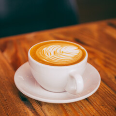 Coffee mug with foam art leaf