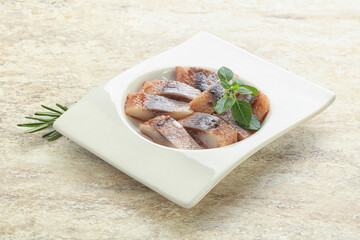 Delicous sliced herring fillet in grape sauce