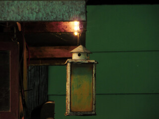 old fashioned lantern hanging in the wall