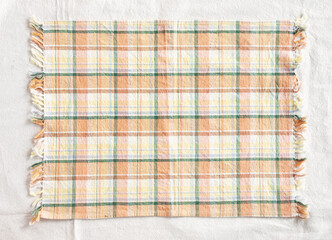 Yellow checkered pattern background kitchen cloth, picnic towel, tableware, table mat, top view.