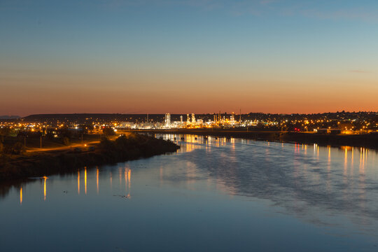 Lights from an oil refinery light up Great Falls and the Missouri River in Montana, USA.