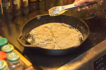 Food cooking in cast iron pan