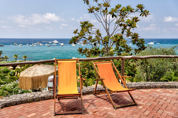 Rustic stairs and pathways amongst the colourful beach chairs and umbrellas in the hot springs on...