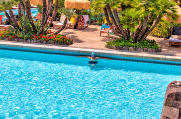 Teenage boy enjoying the hot springs on the island of Ischia in Italy