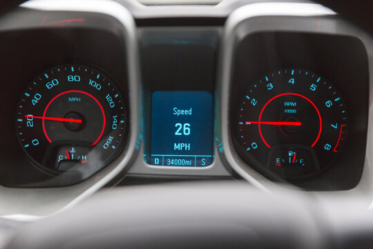Vehicle speedometer reading 26 miles per hour, with other guages in cluster