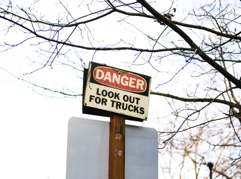 Road sign that says: Danger - Look Out For Trucks