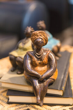 African figure, decorative bookend, figure of an adult woman in traditional clothing and hat