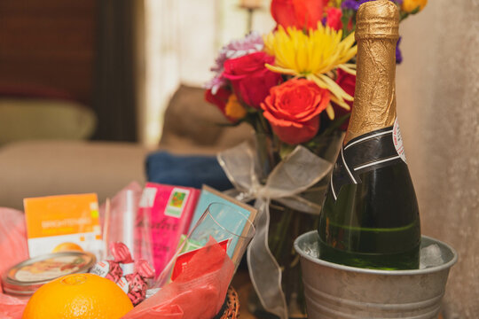 Champagne, flowers, and giftbasket