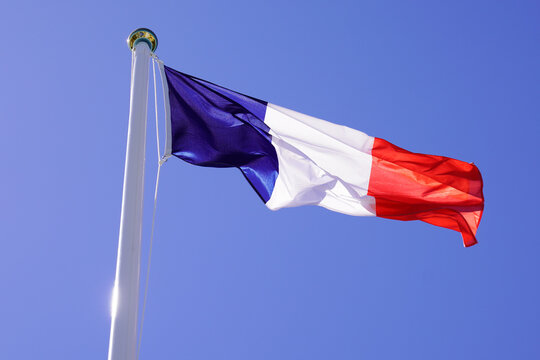 French tricolors blue white red flag fluttering waving front on mat and blue sky
