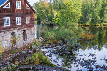 Fototapeta na wymiar Old Mill house at a river in the woodland